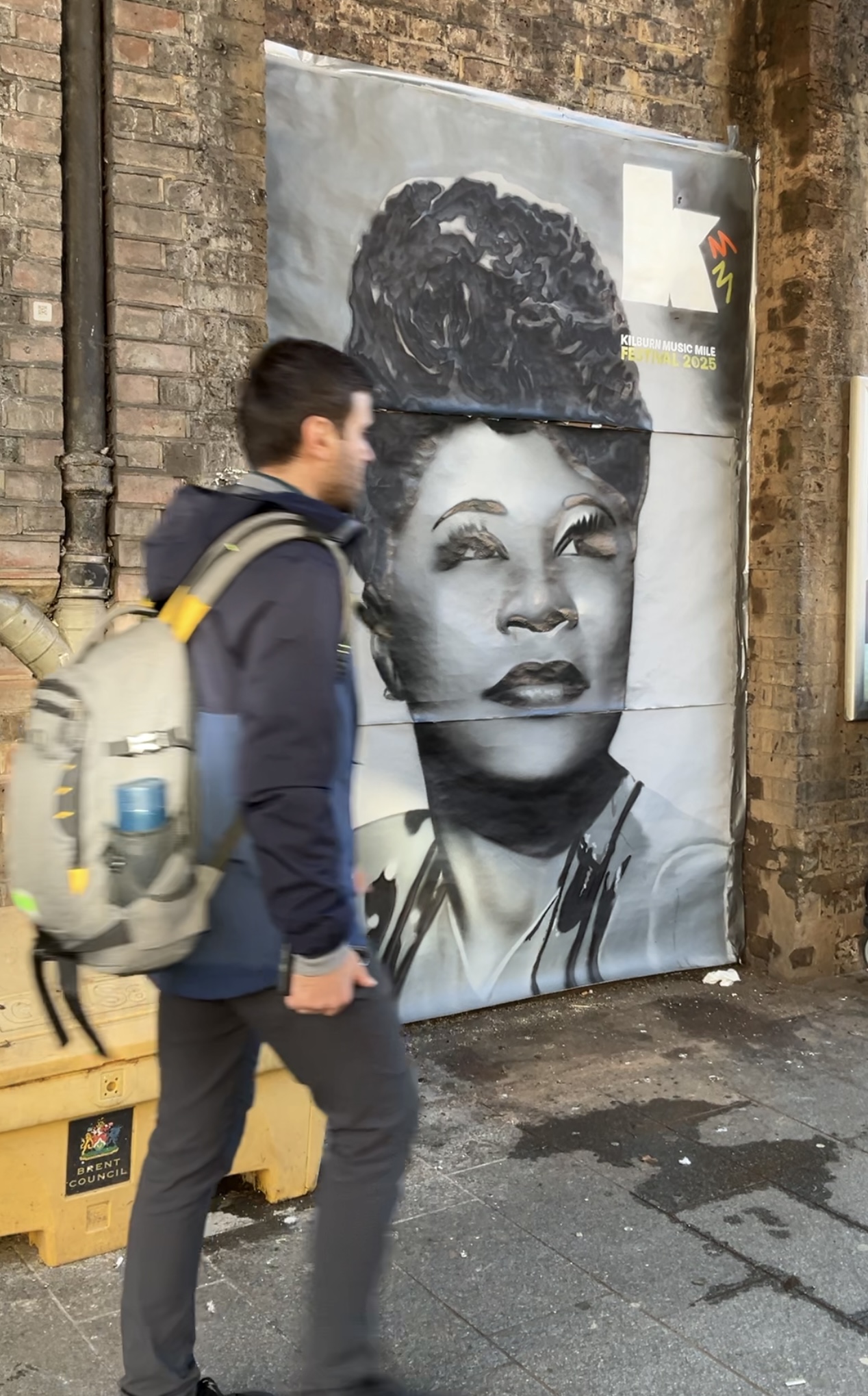 Ella Fitzgerald street artwork with passer-by